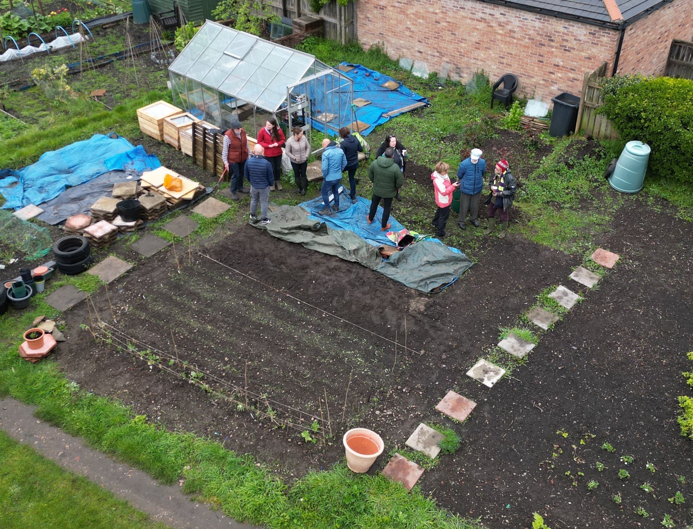 A group of volunteers stand next to an allotment site in Bawtry. 